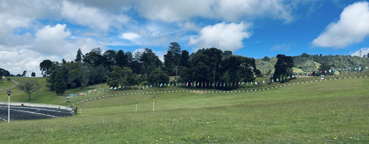 Flags across the green field at the Puente de Boyacá historic site, where Stage 2 begins